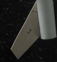 Glue the fins to the rear section of the rocket.