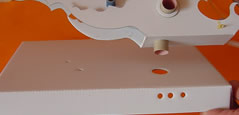 PLace the base through the hole in the stand.